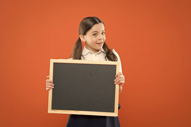 task list. write hometask. back to school. happy teachers day. 1 september. small girl demonstrate announcement. happy small school girl with chalkboard. blackboard for copy space. information - 写真・画像