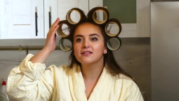 Woman Touching big curlers on his head kitchen - Metraje, vídeo