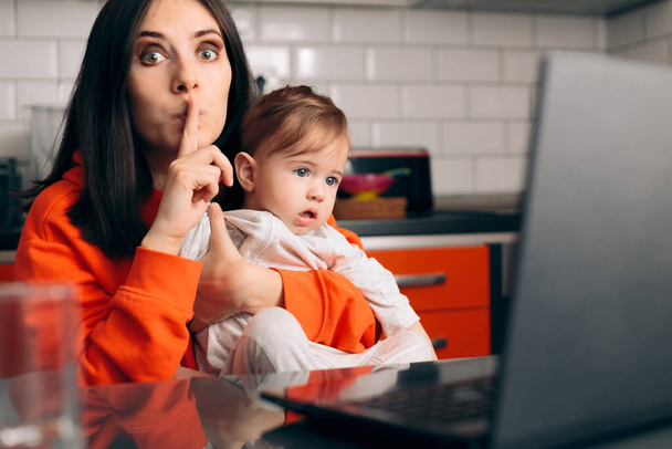 Mother with Baby Asking for Silence Watching Cartoon - Photo, Image