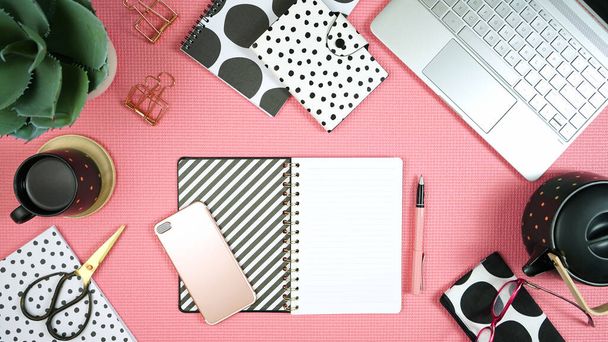 Desktop workspace with laptop and modern pink, black and white accessories. - Photo, Image