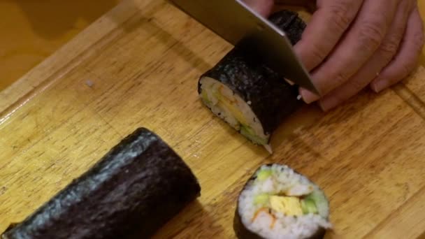 Close-up 4K slow-motion video of salmon sushi making. The sauce is