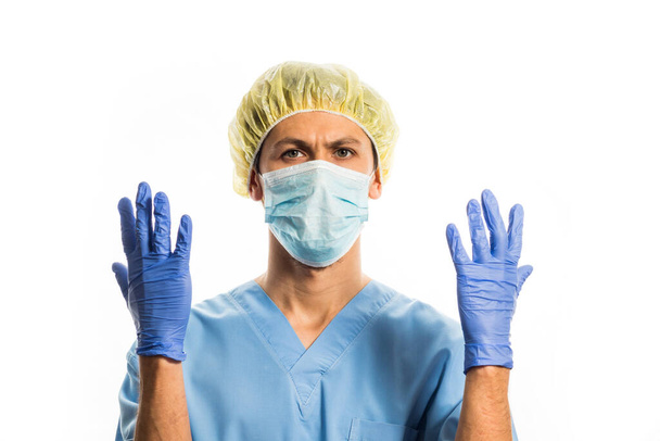 doctor in medical clothes with rubber gloves and a mask, portrait on a white background - Photo, Image