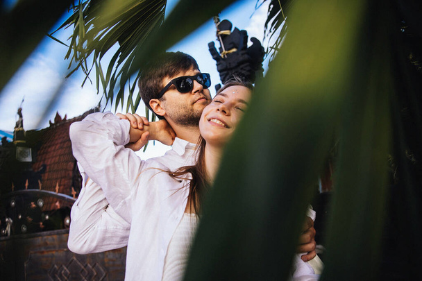 couple in love hugs and has fun on a romantic walk on the exotic island of Bali in Indonesia near palm trees - Фото, зображення