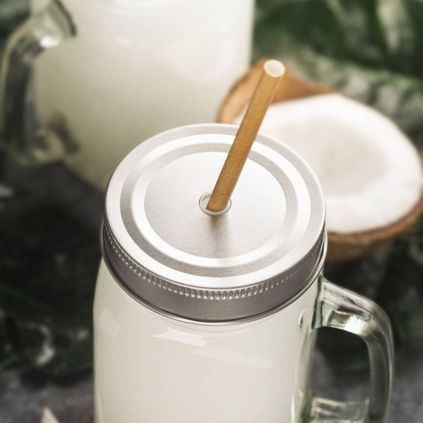 Coco milk drink in glass jar with handle close up - Zdjęcie, obraz