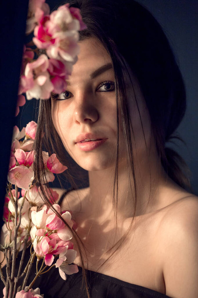 gorgeous young girl with colorful flowers, studio portrait - Фото, изображение