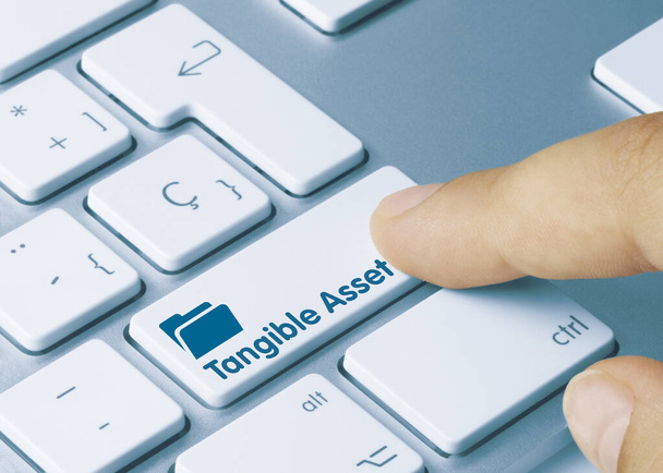 Tangible Asset Written on Blue Key of Metallic Keyboard. Finger pressing key. - Photo, Image
