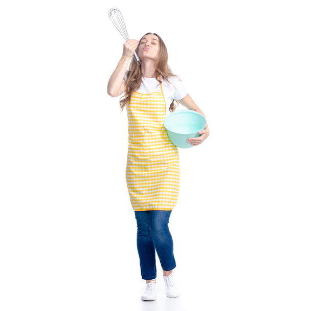 Woman in blue apron with kitchen bowl whisk corolla in hand - Foto, immagini