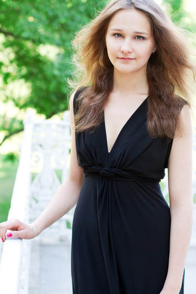 Young woman in a long black dress - 写真・画像