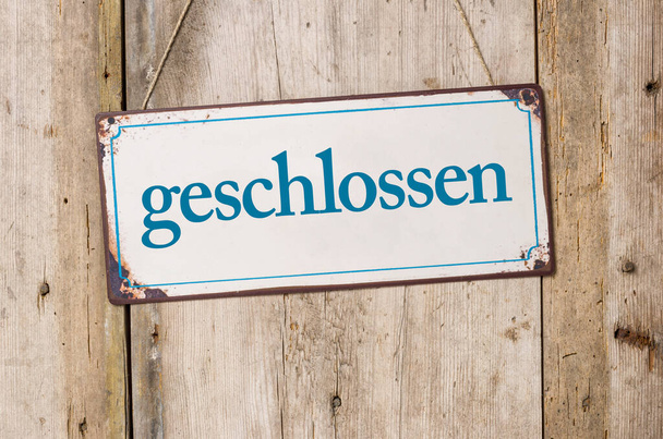 Old metal sign in front of a rustic wooden wall - Closed - geschlossen German - Photo, Image