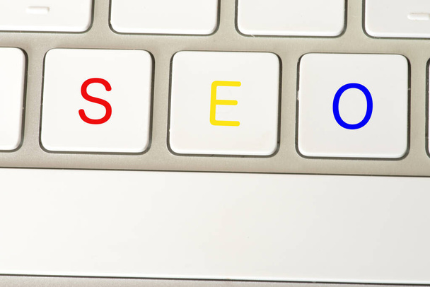 A PC keyboard with the keys for SEO Search Engine Optimization - Photo, Image