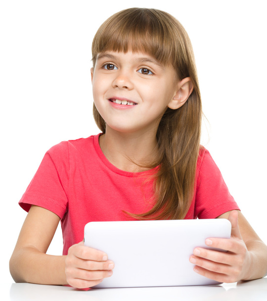 Young girl is using tablet - Φωτογραφία, εικόνα