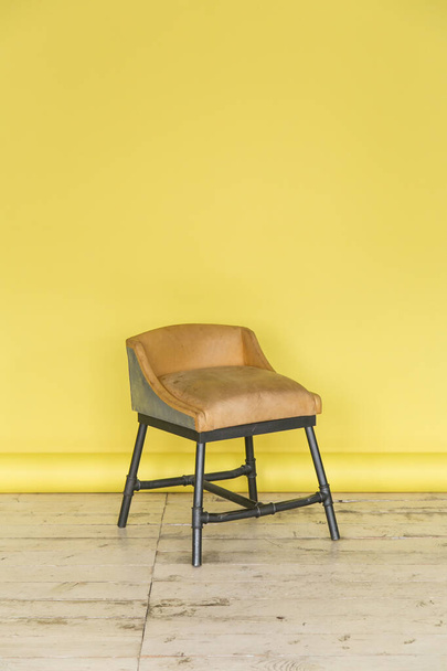 The working space of the photo studio with a yellow paper background and chair. - Photo, Image
