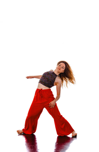 Adorable modern slim hip-hop style teenage girl dancing isolated on a white studio background - Foto, imagen