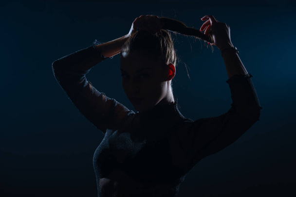 Dark contrast portrait of beautiful young woman with ponytail hairstyle - Φωτογραφία, εικόνα