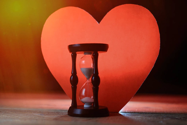 Love and time. Heart and hourglass. The concept of transience, ending love. - Photo, Image