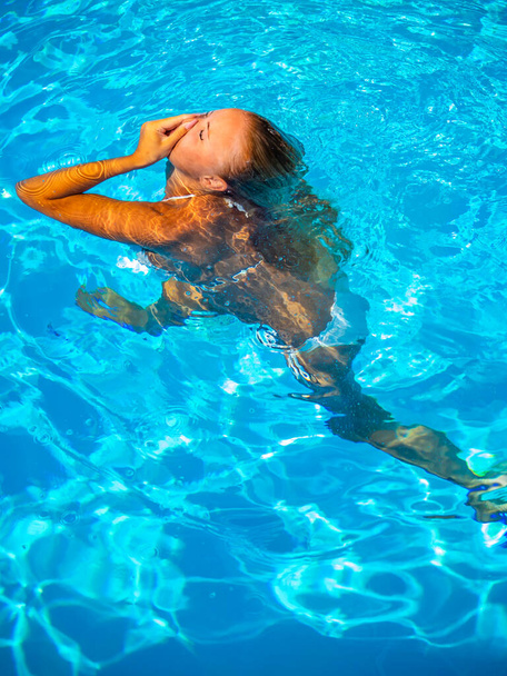 woman in luxury five stars  spa resort in the swimming pool.  - Fotó, kép