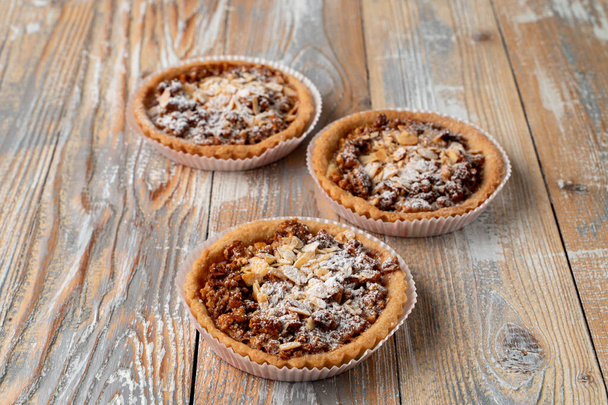 Homemade tartlet with nuts and honey on rustic wooden table  - 写真・画像