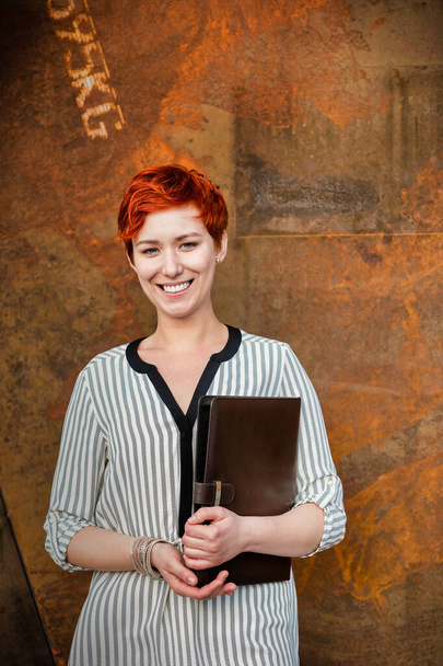 Young attractive businesswoman standing while holding document - Fotografie, Obrázek