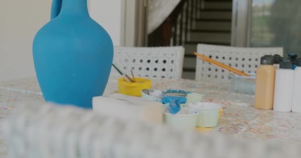 Blue handcraft vase made from argil with painting equipment. - Video, Çekim