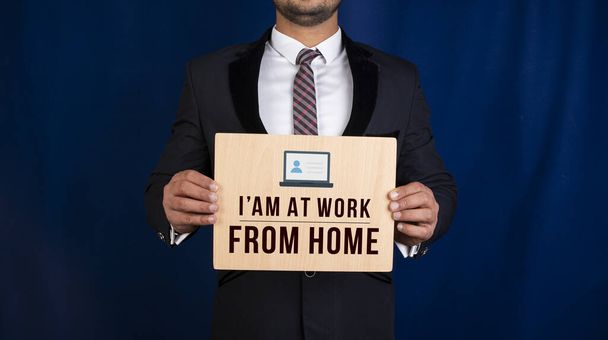Professional holding work from home sign in hands - Photo, Image