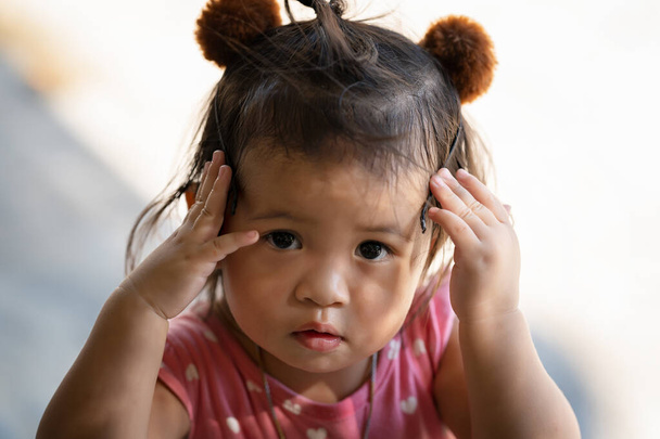 Closeup portrait of a cute little thai girl thinking, Close up portrait of a cute little girl  - Photo, Image