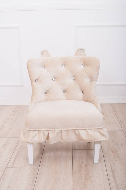 Cute beige soft chair with wings for the little princess's nursery. Children's furniture. Furniture for little girls - Photo, image