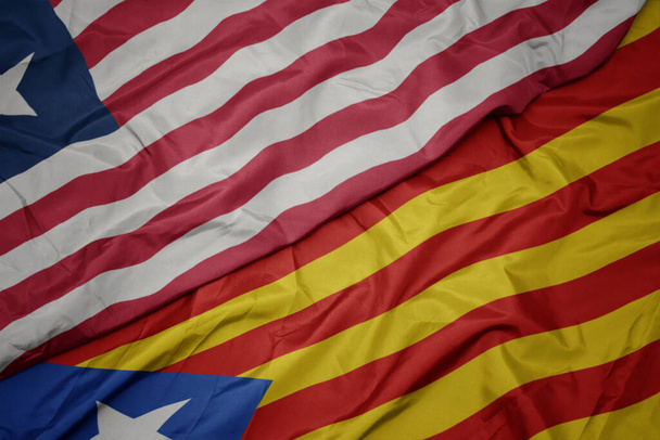 sventolando bandiera colorata della Catalogna e bandiera nazionale della Liberia. macro
 - Foto, immagini