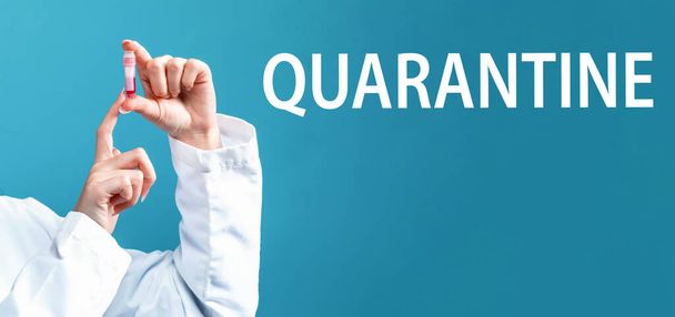 Quarantine theme with a doctor holding a laboratory vial - Valokuva, kuva