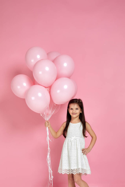 happy cute little child girl posing with pastel pink air balloons - Фото, изображение