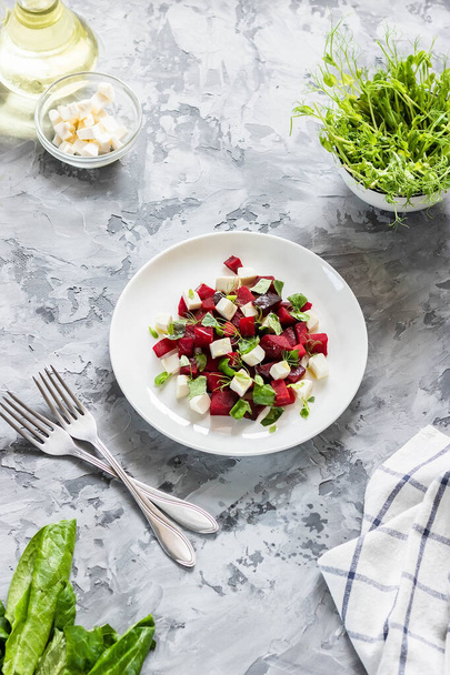 Light spring and summer salad. Baked beets with feta cheese and shoots of young peas - Photo, Image