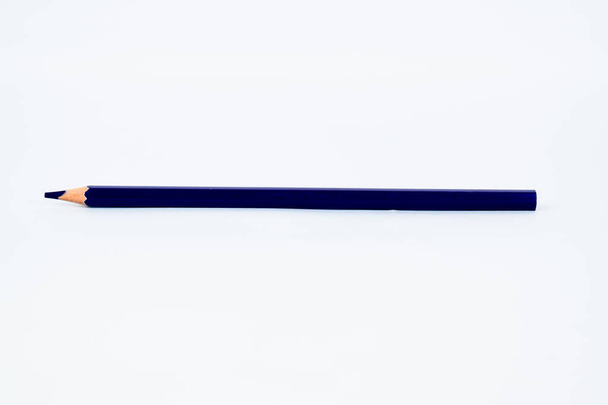 A deep blue colored sharp wood pencil crayon isolated on a white background - Photo, Image