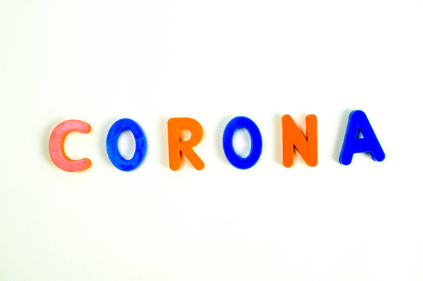 CORONUna palabra escrita en varios bloques de letras de colores sobre un fondo blanco aislado
 - Foto, Imagen