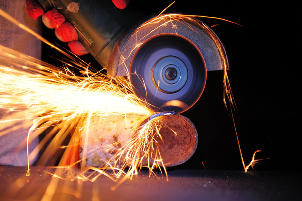 Worker cutting metal with grinder - Photo, Image