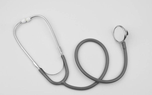 A single normal stethoscope isolated on top of a white color empty paper background - Photo, Image