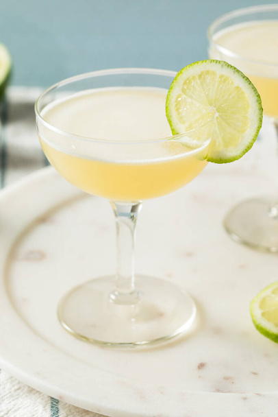 Homemade Vokda Gimlet Cocktail in a Coupe Glass - Foto, Imagen
