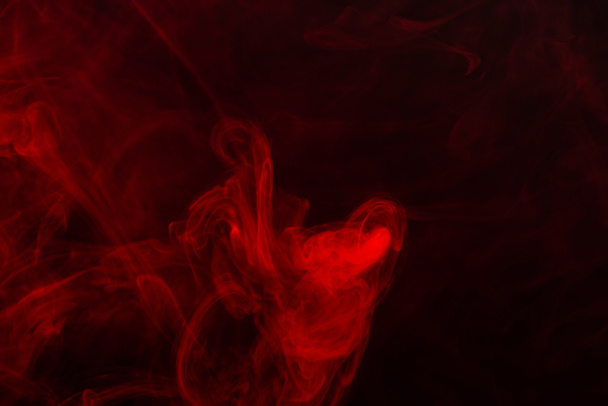 Red steam on a black background. Copy space. - Photo, Image