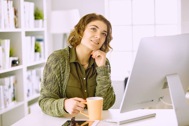 Young woman working with graphic tablet in office - Photo, Image