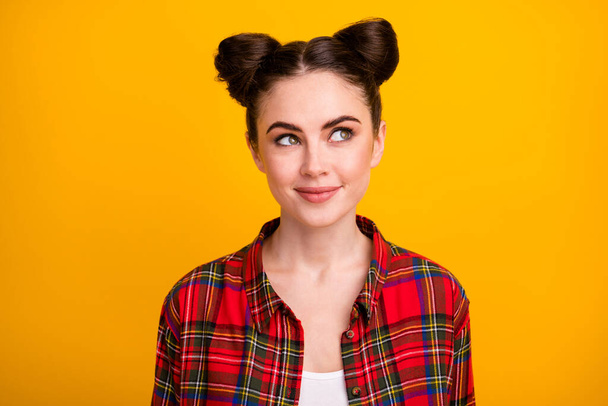 Closeup photo of attractive student lady two cute buns look side empty space intelligent dreamer girl wear casual checkered shirt isolated vivid yellow color background - Φωτογραφία, εικόνα