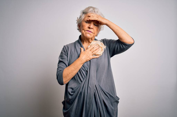 Senior beautiful grey-haired woman wearing casual dress standing over white background Touching forehead for illness and fever, flu and cold, virus sick - Fotografie, Obrázek