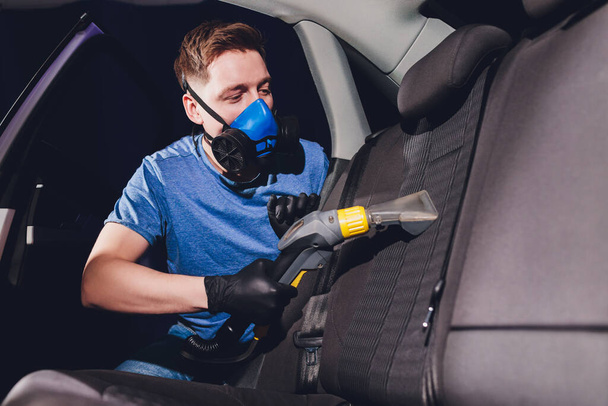 Car interior textile seats chemical cleaning with professionally extraction method. Early spring cleaning or regular clean up. - Φωτογραφία, εικόνα