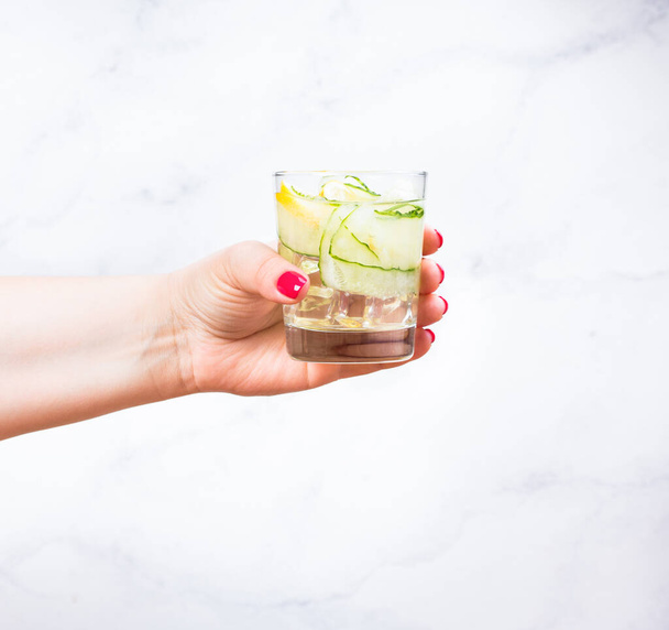 Nutritious detox water with lemon and cucumber in a glass. - 写真・画像