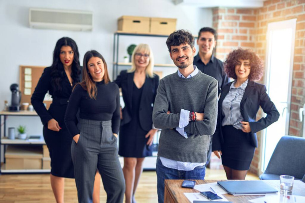 Group of business workers smiling happy and confident. Posing together with smile on face looking at the camera, young handsome man with crossed arms at the office - Фото, зображення