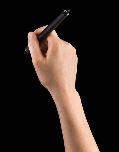 Hand holding digital graphic pen and drawing something isolated on black - Photo, Image