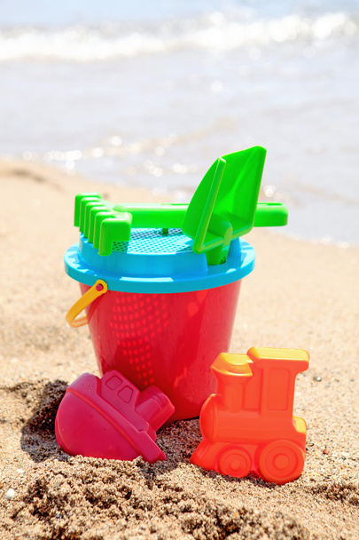 Colorful plastic toys at the beach - Fotoğraf, Görsel