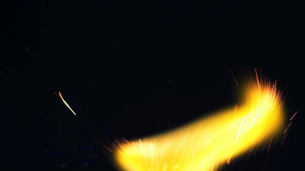 ボンファイアのマクロ写真が火花を散らします。炎が爆発し爆発する。爆発マイクロ輝きます。ミニ花火。まだ黒の背景に赤いカメラで撮影。スパークポスター,バナー,壁紙,テクスチャ. - 写真・画像