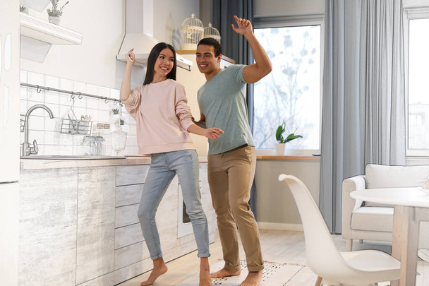 Lovely young interracial couple dancing in their new house  - Zdjęcie, obraz