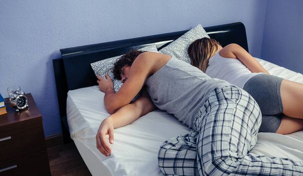 Couple sleeping on their backs uncovered - Photo, Image