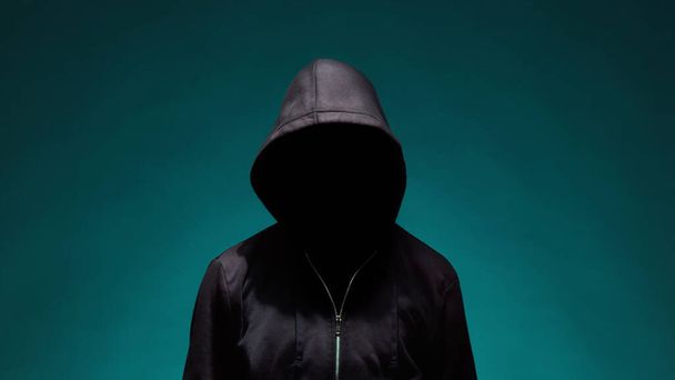 Portrait of computer hacker in hoodie. Obscured dark face. Data thief, internet fraud, darknet and cyber security concept. - Foto, afbeelding