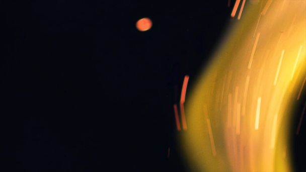 Macro photo of Bonfire sparks. Fire Flames bursts, blasts. Explosion micro sparkles. Mini Fireworks. Shooting on Red camera still on black background. Beautiful leaks overlay spark poster, banner, wallpaper, backdrop, texture. - Fotografie, Obrázek