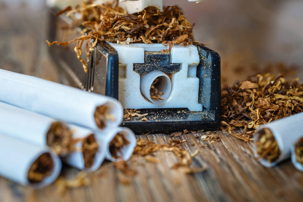 hand-made cigarettes at home using a manual machine - Photo, Image